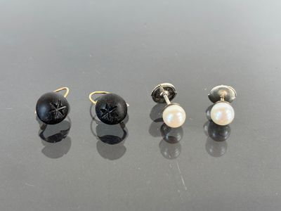 three pairs of black and white pearl earrings on a black surface
