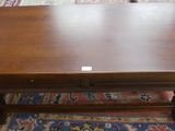 a wooden table with a small drawer on top of it