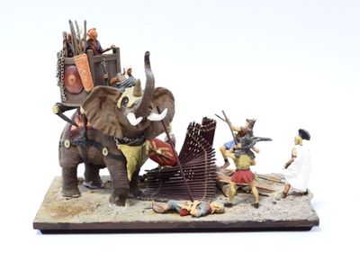 a figurine of a group of people riding on an elephant