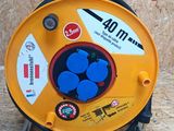 a yellow reel with blue buttons on it on a stand