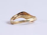 an image of a gold ring on a white surface