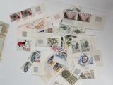 a pile of stamps on a table next to a pair of scissors
