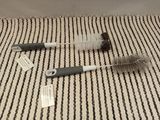 two brushes that are laying on a striped surface