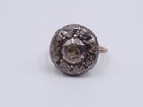 a close up of a silver ring on a white surface