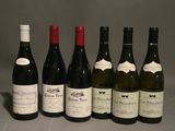several bottles of wine are lined up on a table