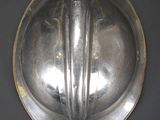 a silver plate with a handle on the wall