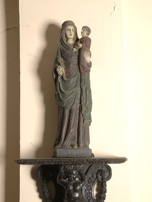 a statue of a woman holding a child on top of a table