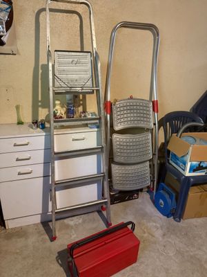 two ladders and a chair in a room