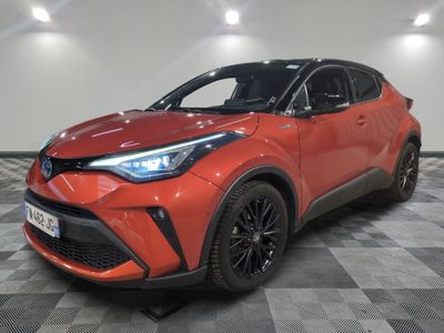 a red toyota c - hr suv parked on a checkered floor