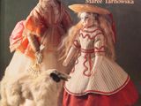 a book with a picture of two dolls and a dog