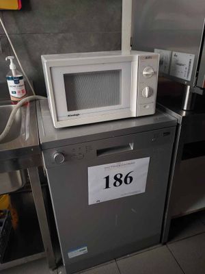 a microwave sitting on top of a dishwasher in a kitchen