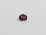 an oval cut pink tourmaline gems on a white surface