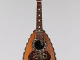 a guitar hanging from the ceiling in a room