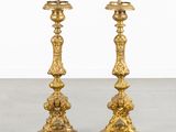 pair of antique brass candlesticks on pedestal