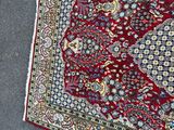 rug laying on the ground with a cat laying on top of it