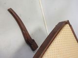 a chair that has a wooden handle on it