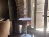 a small table with a wine glass on it in front of a door