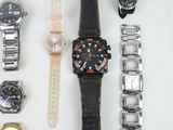 a lot of watches that are laying out on the table
