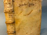 an old book with writing on it sitting on a table