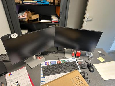 un bureau équipé de deux écrans et d'un clavier