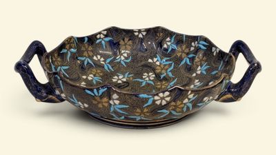 a blue and white bowl with flowers on it