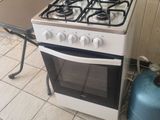 a gas stove and a table in a kitchen