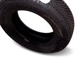 an image of a tire on a white background with a sticker on it