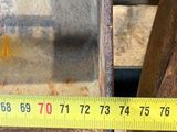 a measuring tape on the side of a piece of metal