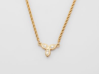 a gold necklace with a butterfly pendant on a chain