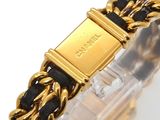 an image of a gold and black bracelet with a chain around it