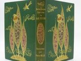 a green book with a gold design on it
