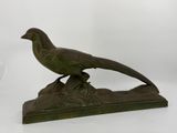 statue of a pheasant on a rock on a white background