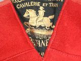 a close up of a red jacket with a black and gold label