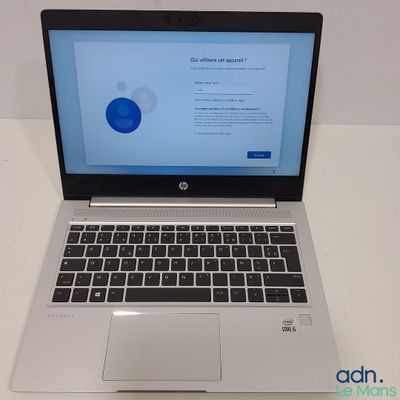 an open laptop computer sitting on top of a white table