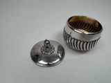 an image of a silver cup with a lid on a table