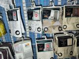 many electronic devices hanging on a wall in a room