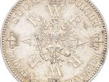 a close up of a silver coin with a crown on it