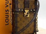 a louis vuitton handbag with a chain around it