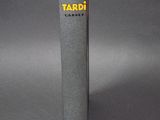 a close up of a book on a table with a gray background