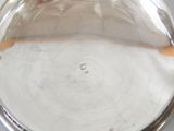 a silver plate with a wooden handle on a table