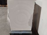 an image of a white washing machine in a warehouse