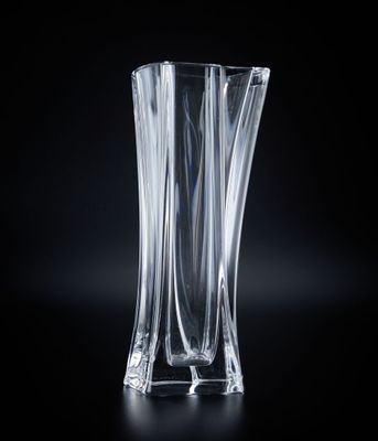 a glass vase that is sitting on a black surface
