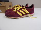 maroon and yellow adidas sneakers with yellow laces on them