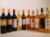 several bottles of wine are lined up in a row on a table