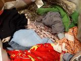 a suitcase full of clothes and a stuffed animal inside of it