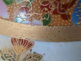 a close up of a vase with a flower design on it