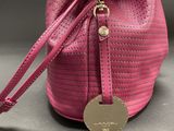 pink bucket bag with a gold metal tag on the handle