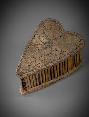 a heart shaped comb sitting on top of a table