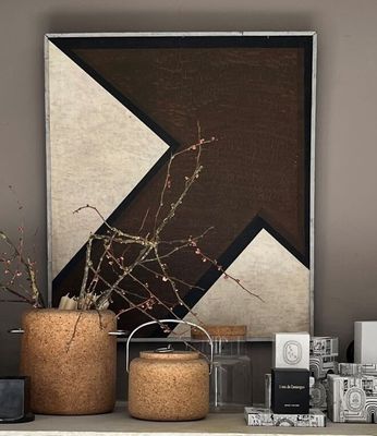 two vases on a shelf with a painting in the background