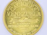 an image of a close up of a gold coin on a white surface